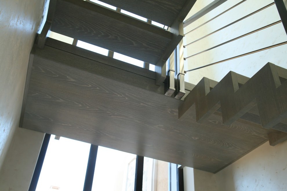 Modern metal stair covered by patina oak