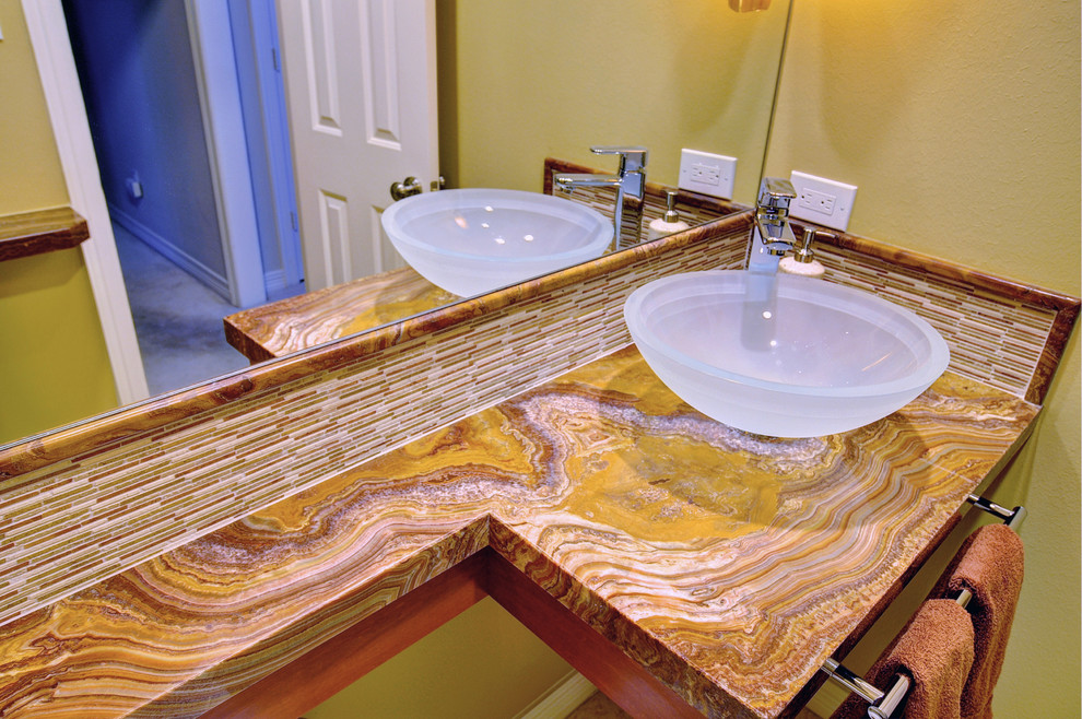 This is an example of a contemporary bathroom in Dallas with a vessel sink and onyx benchtops.