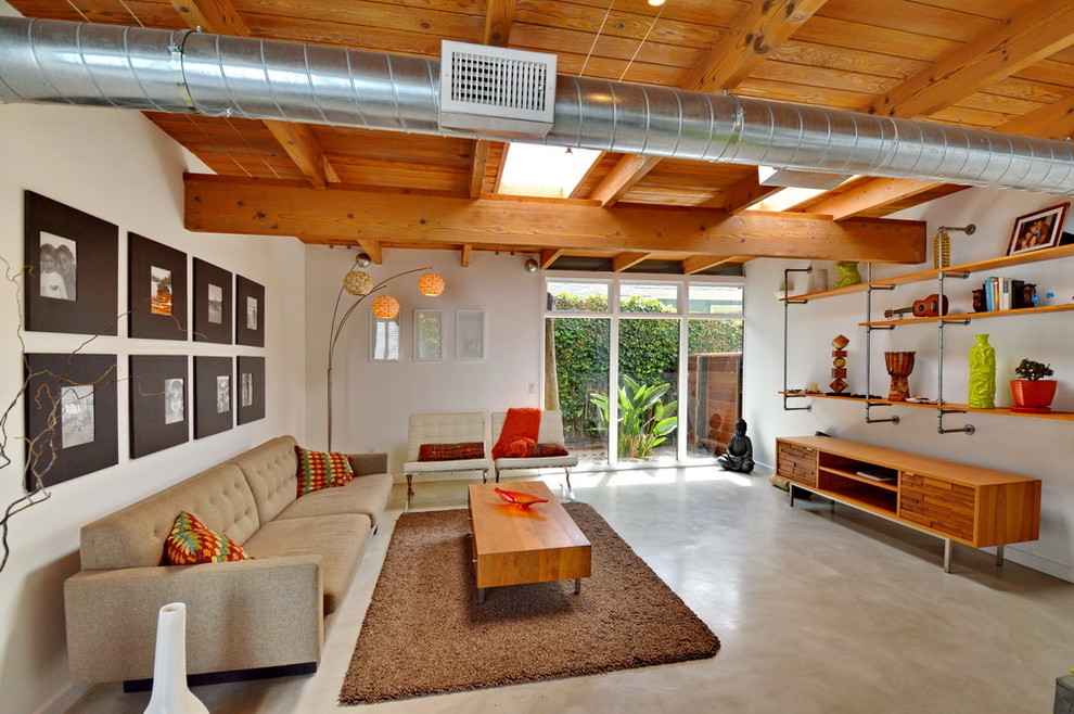 Inspiration for a mid-sized midcentury open concept living room in Los Angeles with white walls, concrete floors and no tv.