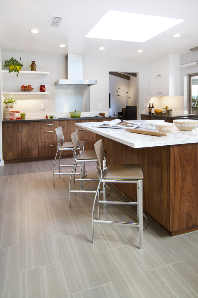 This is an example of a large contemporary u-shaped eat-in kitchen in Phoenix with an undermount sink, flat-panel cabinets, brown cabinets, marble benchtops, grey splashback, stainless steel appliances, ceramic floors and with island.