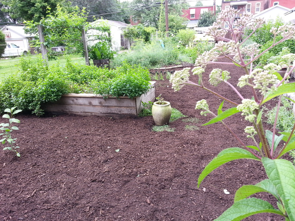 Photo of a mid-sized traditional backyard full sun formal garden in St Louis with a vegetable garden and brick pavers.