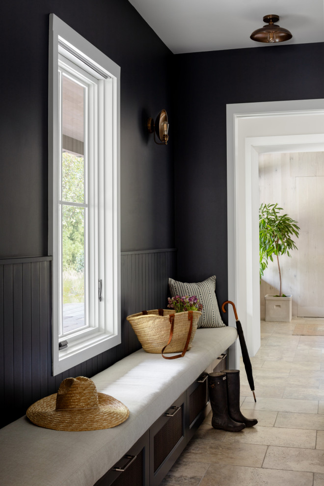 Inspiration for a mid-sized country travertine floor, beige floor and wood wall single front door remodel in DC Metro with black walls and a black front door