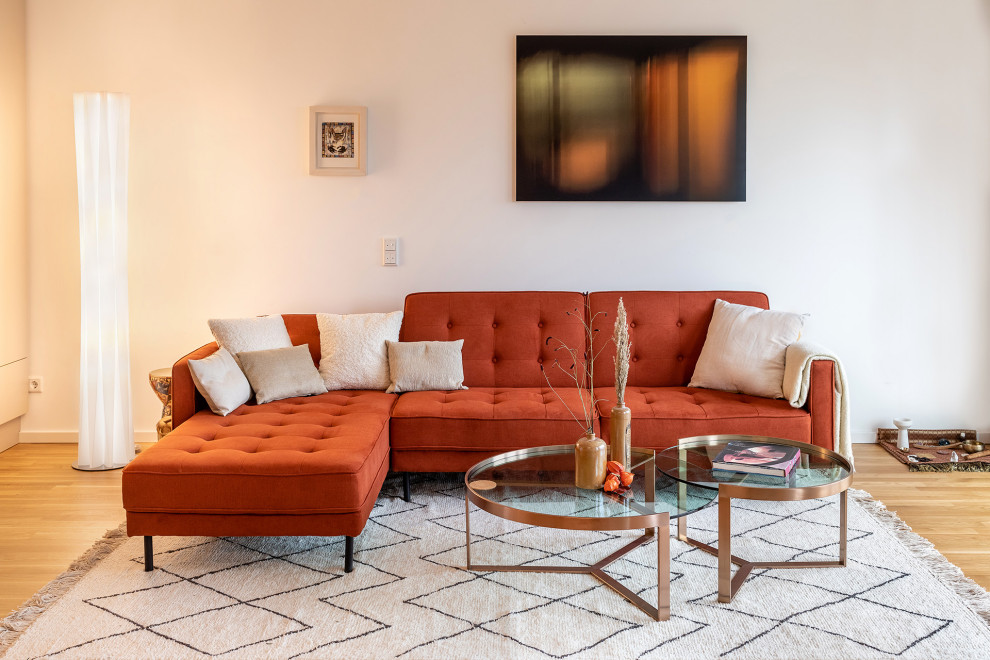 Imagen de sala de estar actual con paredes beige y suelo de madera clara