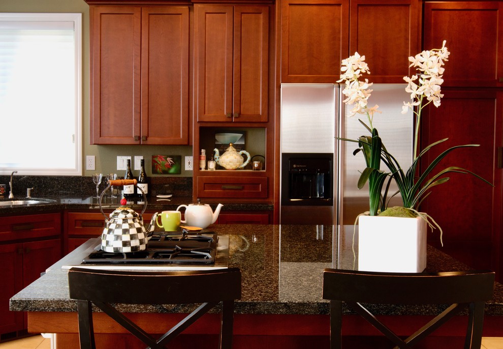 Large eclectic u-shaped ceramic tile eat-in kitchen photo with a double-bowl sink, recessed-panel cabinets, dark wood cabinets, granite countertops, black backsplash, stone slab backsplash, stainless steel appliances and an island