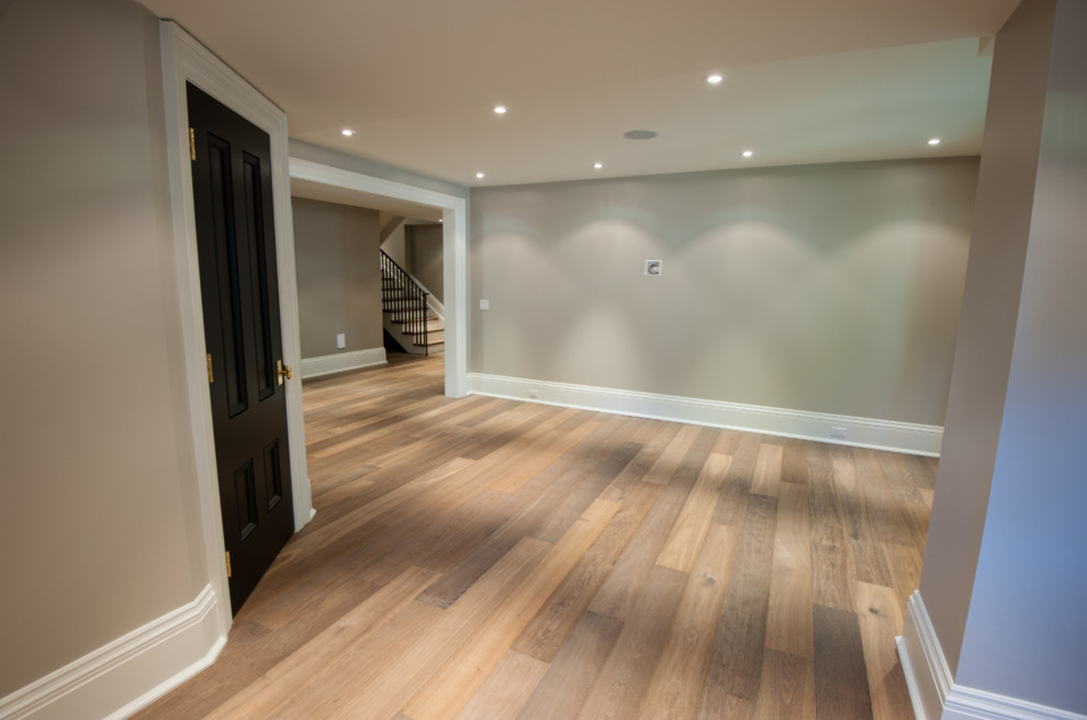 This is an example of a mid-sized contemporary hallway in Toronto with beige walls and light hardwood floors.