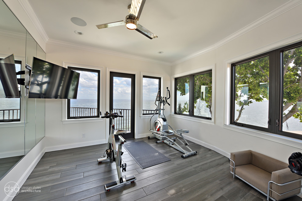 This is an example of a mid-sized mediterranean multipurpose gym in Tampa with white walls, porcelain floors and brown floor.