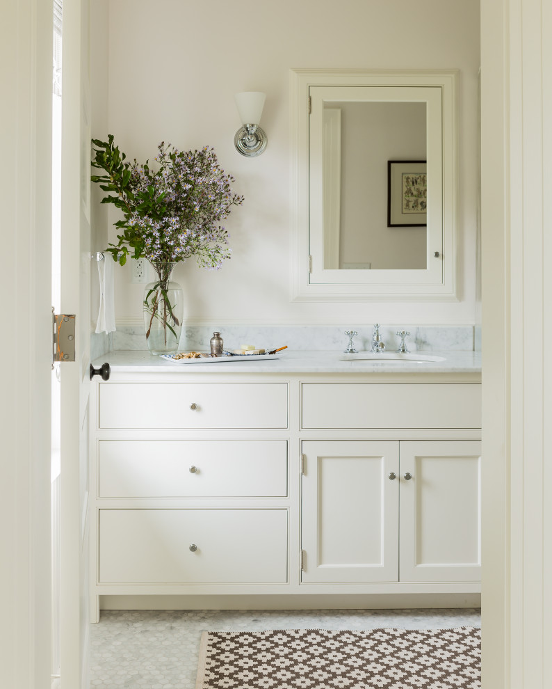 Bathroom - coastal ceramic tile, white floor and single-sink bathroom idea in Boston with recessed-panel cabinets, white cabinets, white walls, white countertops and a built-in vanity