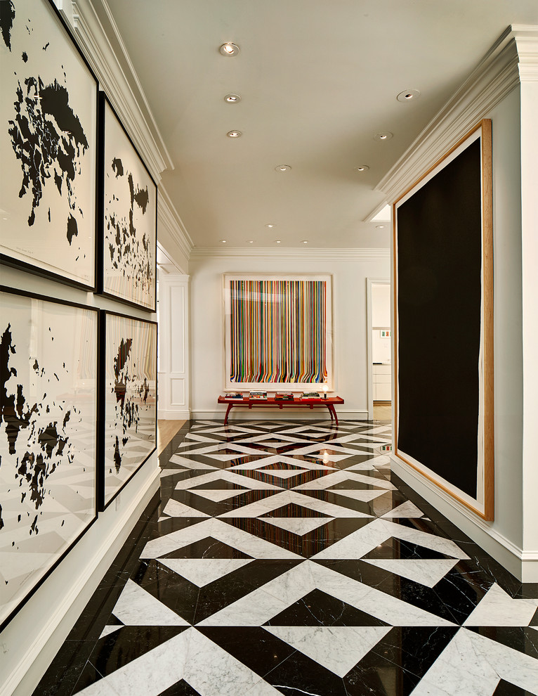 Photo of a large transitional hallway in Dallas with marble floors and white walls.
