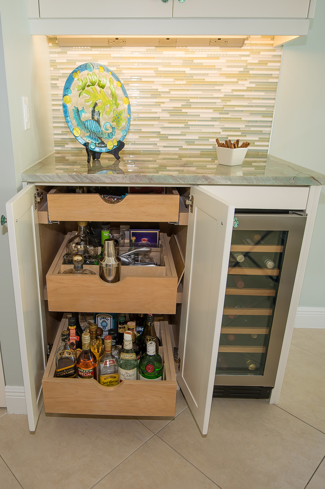 Photo of a modern kitchen pantry in Miami with a single-bowl sink, raised-panel cabinets, white cabinets, quartzite benchtops, glass tile splashback, stainless steel appliances, porcelain floors, with island and green benchtop.
