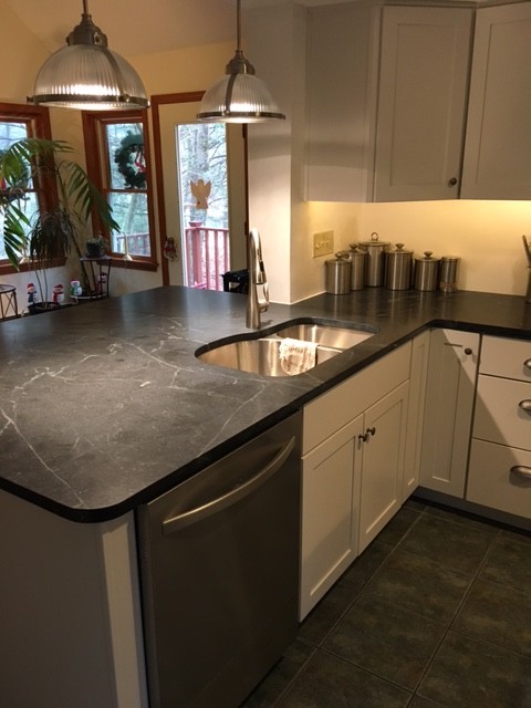 Inspiration for a small transitional u-shaped eat-in kitchen in Boston with an undermount sink, shaker cabinets, white cabinets, soapstone benchtops, stainless steel appliances, ceramic floors, a peninsula and black floor.