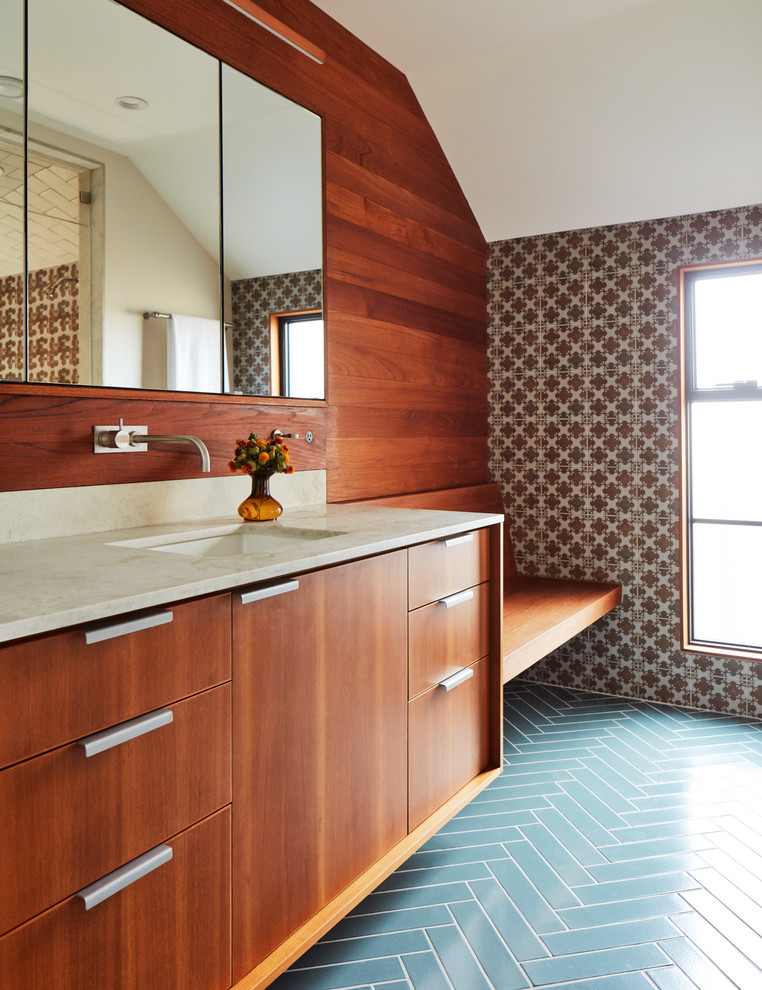 This is an example of a midcentury 3/4 bathroom in San Francisco with flat-panel cabinets, dark wood cabinets, multi-coloured tile, brown walls, an undermount sink, blue floor, a hinged shower door and beige benchtops.