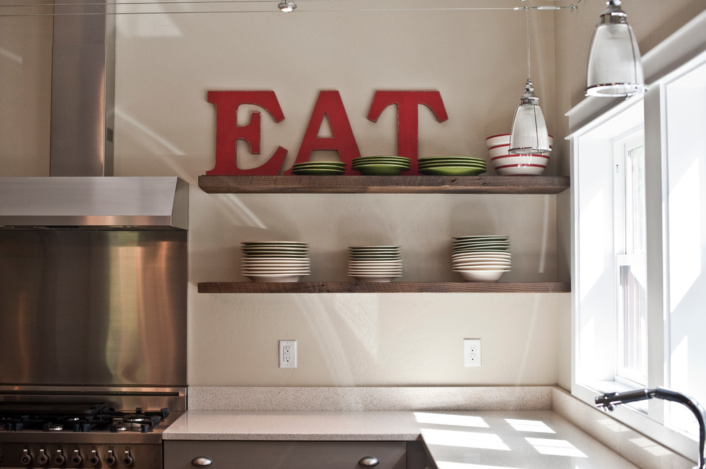 Large transitional l-shaped dark wood floor open concept kitchen photo with a farmhouse sink, flat-panel cabinets, gray cabinets, quartz countertops, white backsplash, stone slab backsplash, stainless steel appliances and an island