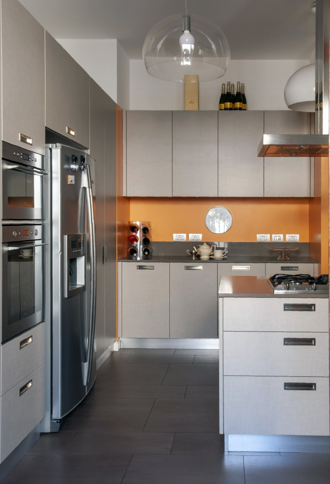 Small arts and crafts u-shaped kitchen in Milan with flat-panel cabinets, grey cabinets, grey splashback, stainless steel appliances, a peninsula, grey floor and grey benchtop.