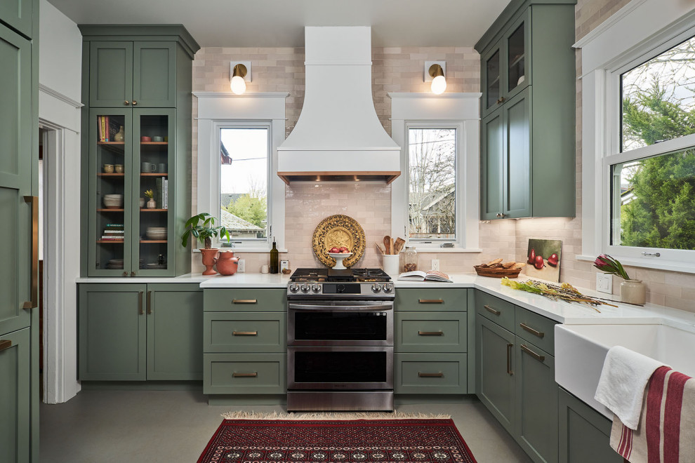 Eat-in kitchen - mid-sized transitional l-shaped beige floor eat-in kitchen idea in Portland with a farmhouse sink, shaker cabinets, green cabinets, quartzite countertops, beige backsplash, ceramic backsplash, no island and white countertops