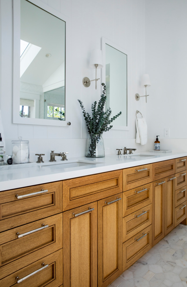 Photo of a large country master bathroom in San Francisco with white walls, engineered quartz benchtops, a hinged shower door, multi-coloured benchtops, a single vanity, a built-in vanity, shaker cabinets, medium wood cabinets, a freestanding tub, a curbless shower, a one-piece toilet, white tile, ceramic tile, marble floors, an undermount sink, multi-coloured floor, an enclosed toilet and planked wall panelling.