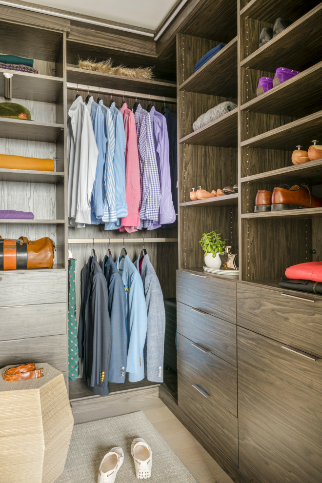 Design ideas for a small modern gender-neutral walk-in wardrobe in Boston with flat-panel cabinets, medium wood cabinets, light hardwood floors and grey floor.