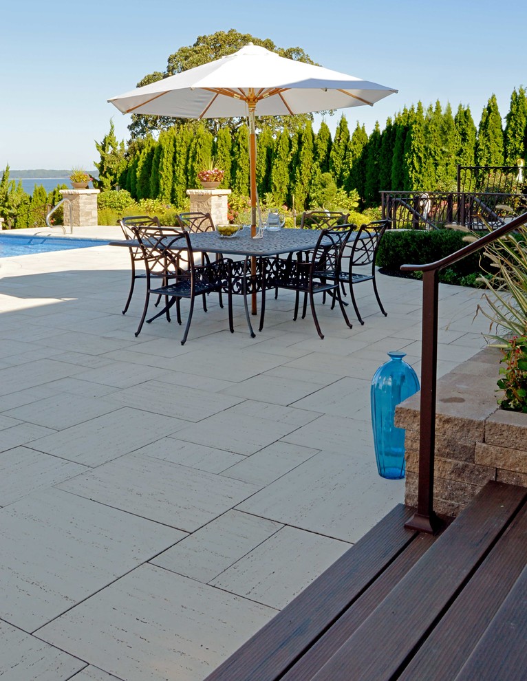 Inspiration for a large beach style backyard patio in New York with an outdoor kitchen and concrete pavers.