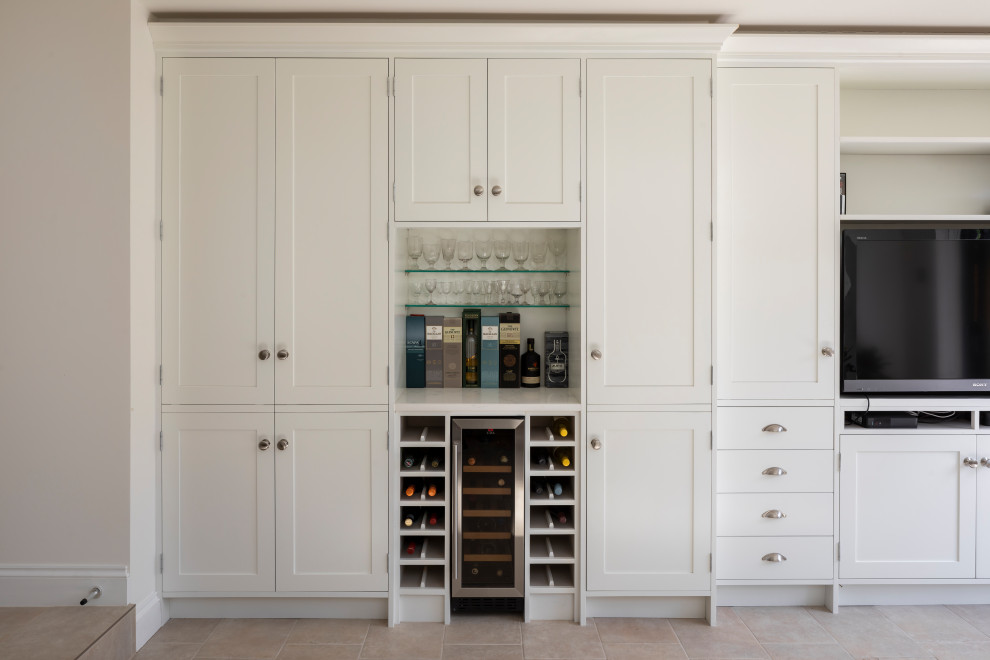 Photo of a mid-sized traditional wine cellar in Nice with terra-cotta floors, storage racks and beige floor.