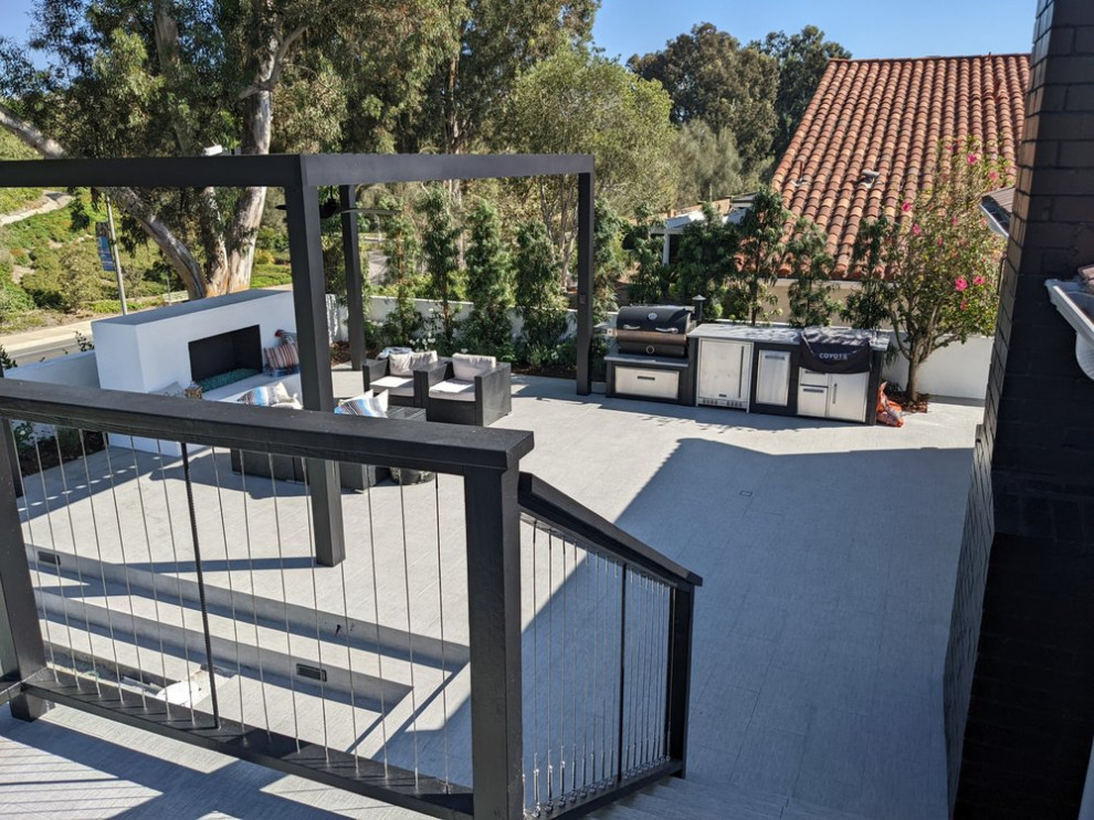 Outdoor kitchen deck - contemporary backyard second story outdoor kitchen deck idea in Orange County with a pergola