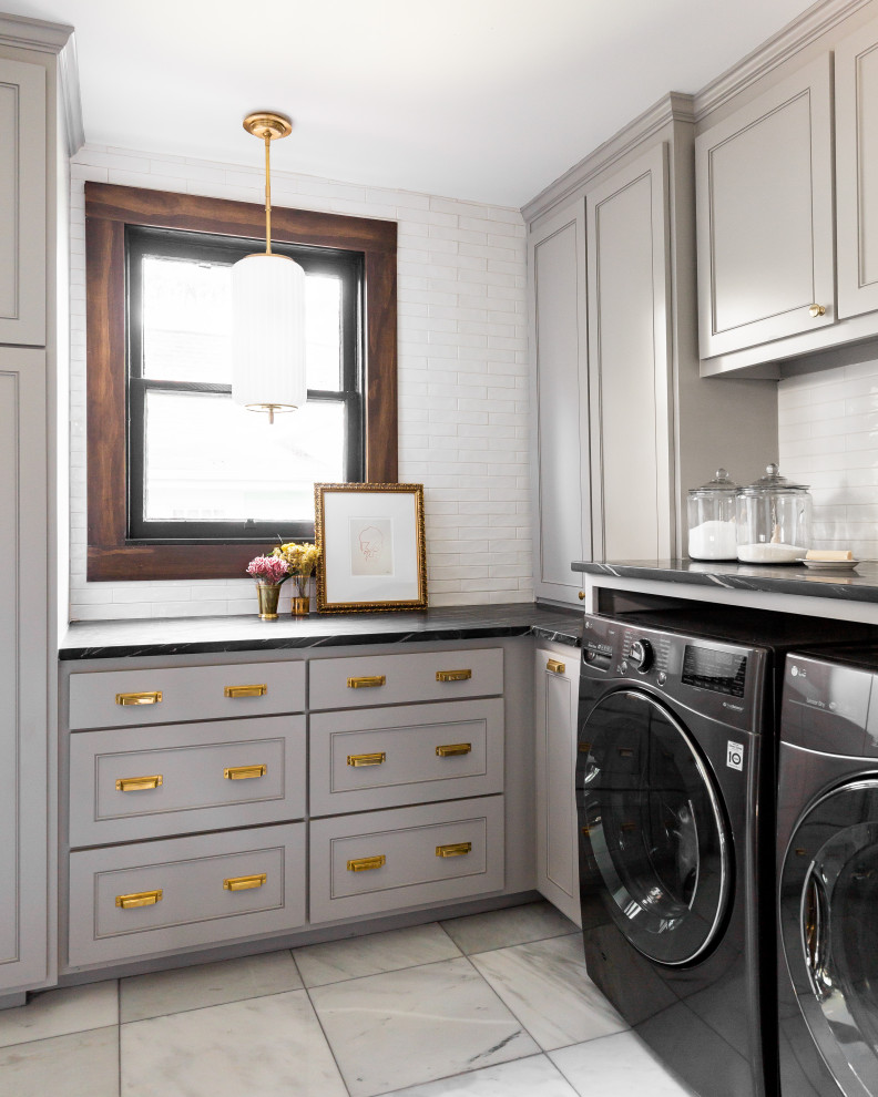 This is an example of a mid-sized traditional dedicated laundry room in Dallas with beige cabinets, white splashback, brick splashback, beige walls, a side-by-side washer and dryer, white floor and black benchtop.