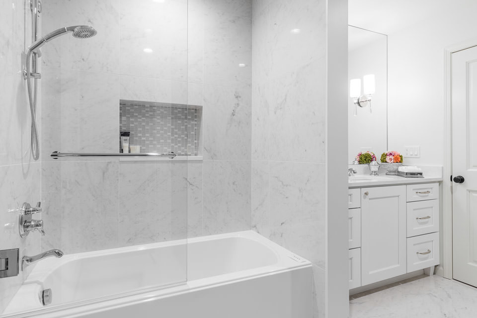 This guest bathroom renovation is a perfect way to create a formal space yet still allow for functional visits when the grandkids come to stay for the weekend. The air-jetted Bain Ultra tub with half