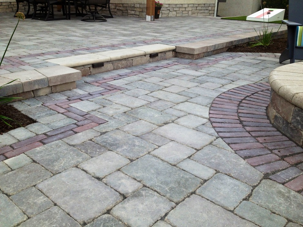 Design ideas for a large contemporary backyard patio in Chicago with a fire feature, brick pavers and a pergola.