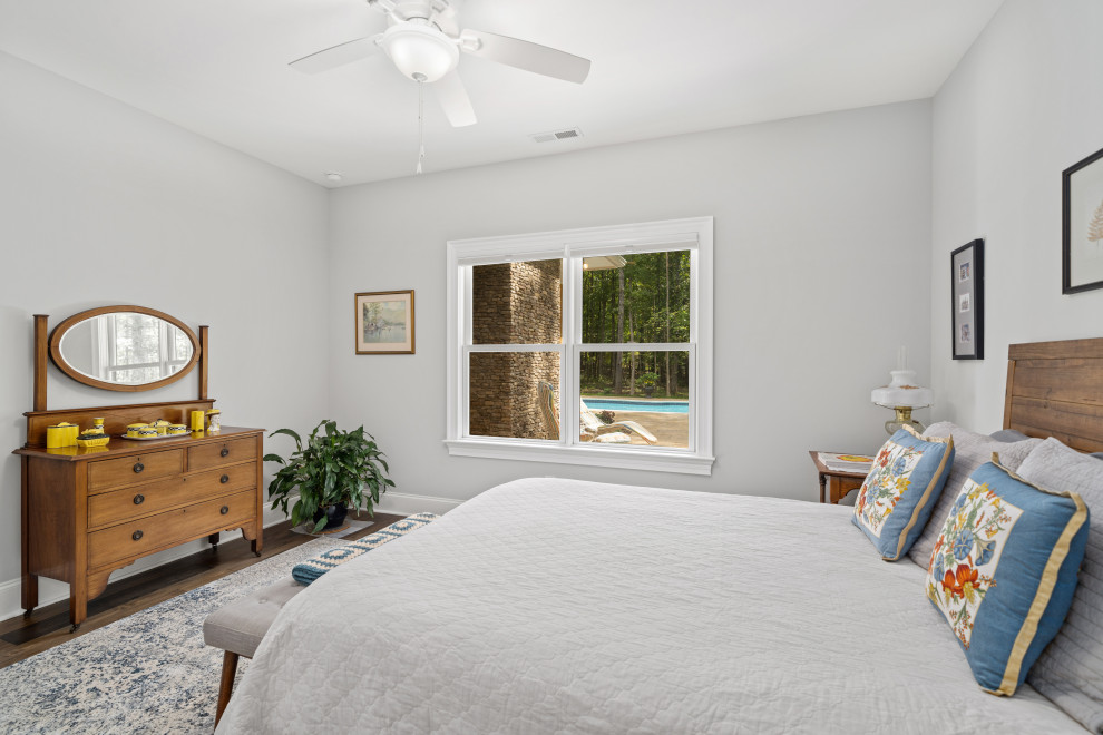 Design ideas for an arts and crafts bedroom in Raleigh with grey walls, dark hardwood floors and brown floor.
