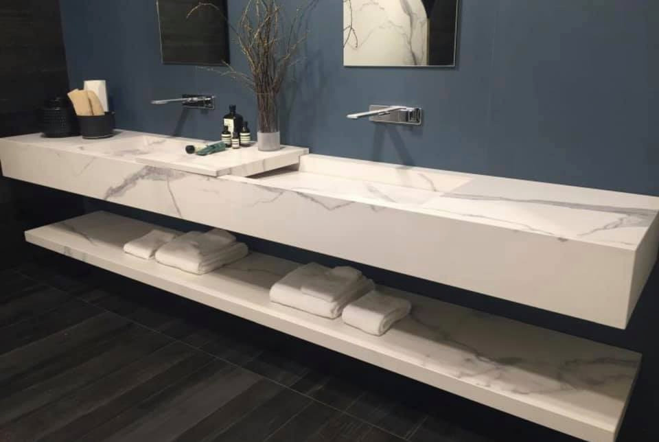 This is an example of a mid-sized modern master bathroom in Austin with open cabinets, grey cabinets, white tile, porcelain tile, blue walls, dark hardwood floors, a trough sink, marble benchtops, brown floor and grey benchtops.