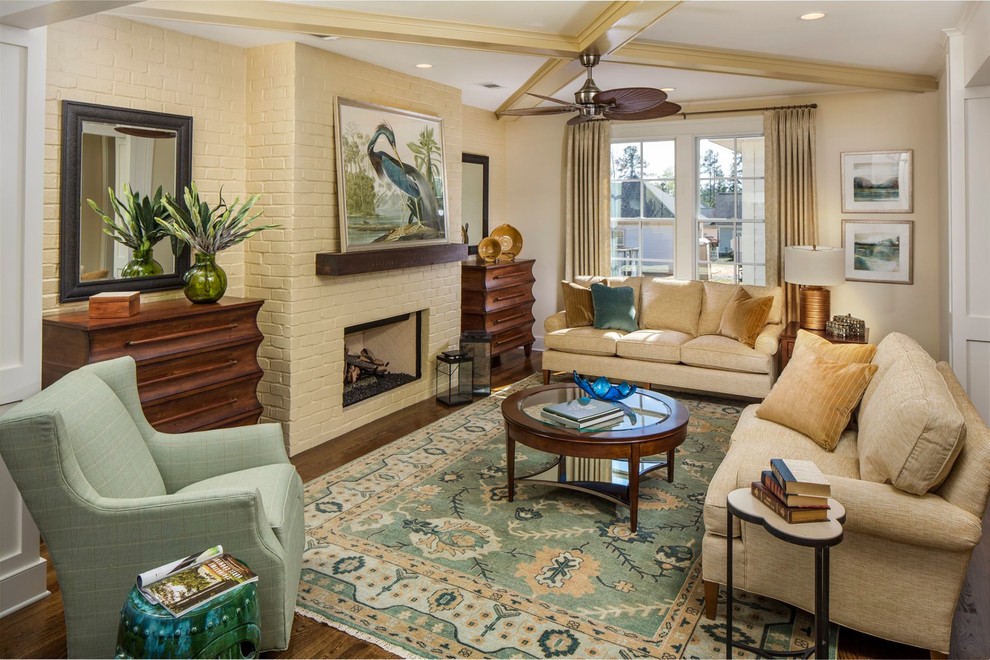 This is an example of a beach style formal enclosed living room in Atlanta with yellow walls, dark hardwood floors, a ribbon fireplace and a brick fireplace surround.