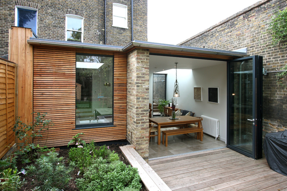 Photo of a contemporary exterior in Buckinghamshire with wood siding and a flat roof.