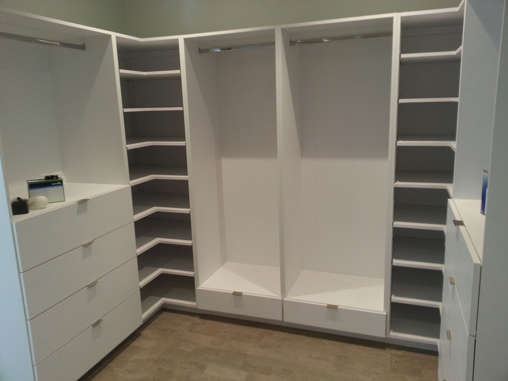 Transitional gender-neutral vinyl floor walk-in closet photo with flat-panel cabinets and white cabinets