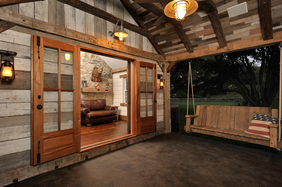 Inspiration for a large rustic backyard concrete patio remodel in New York with a fire pit and a roof extension