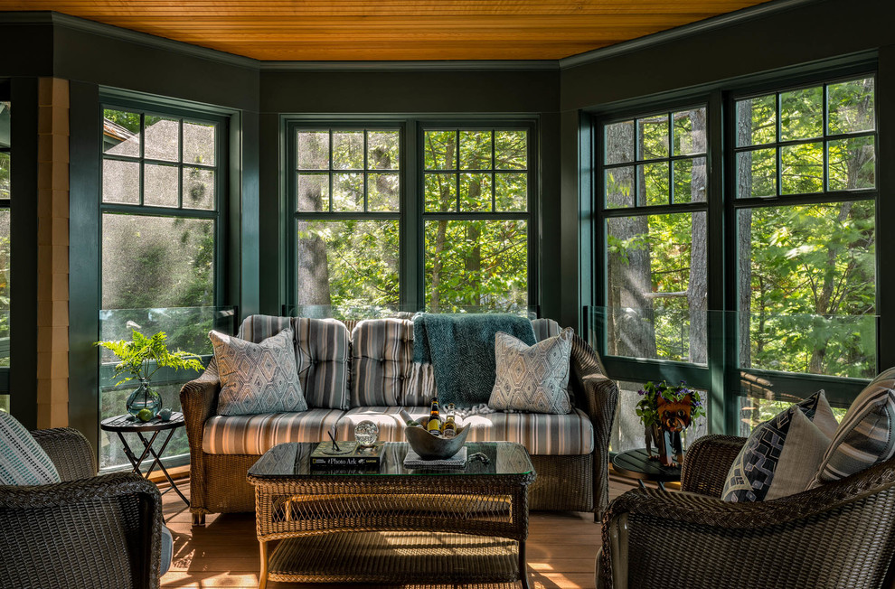 This is an example of an arts and crafts sunroom in Boston with medium hardwood floors, a standard ceiling and brown floor.