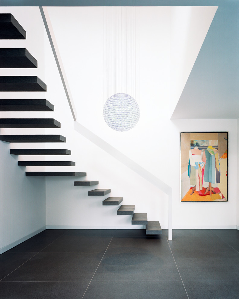 Photo of a mid-sized contemporary l-shaped staircase in Cologne with open risers.
