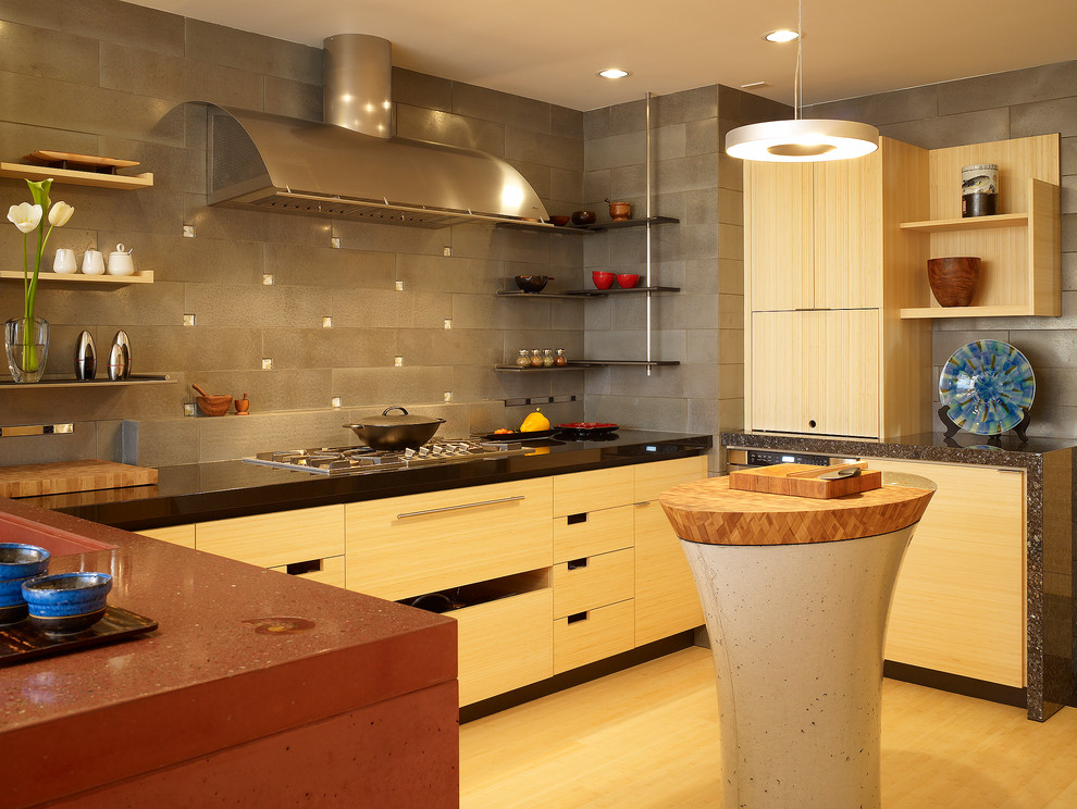 Photo of a mid-sized contemporary u-shaped eat-in kitchen in San Francisco with an undermount sink, flat-panel cabinets, light wood cabinets, concrete benchtops, grey splashback, ceramic splashback, stainless steel appliances and bamboo floors.