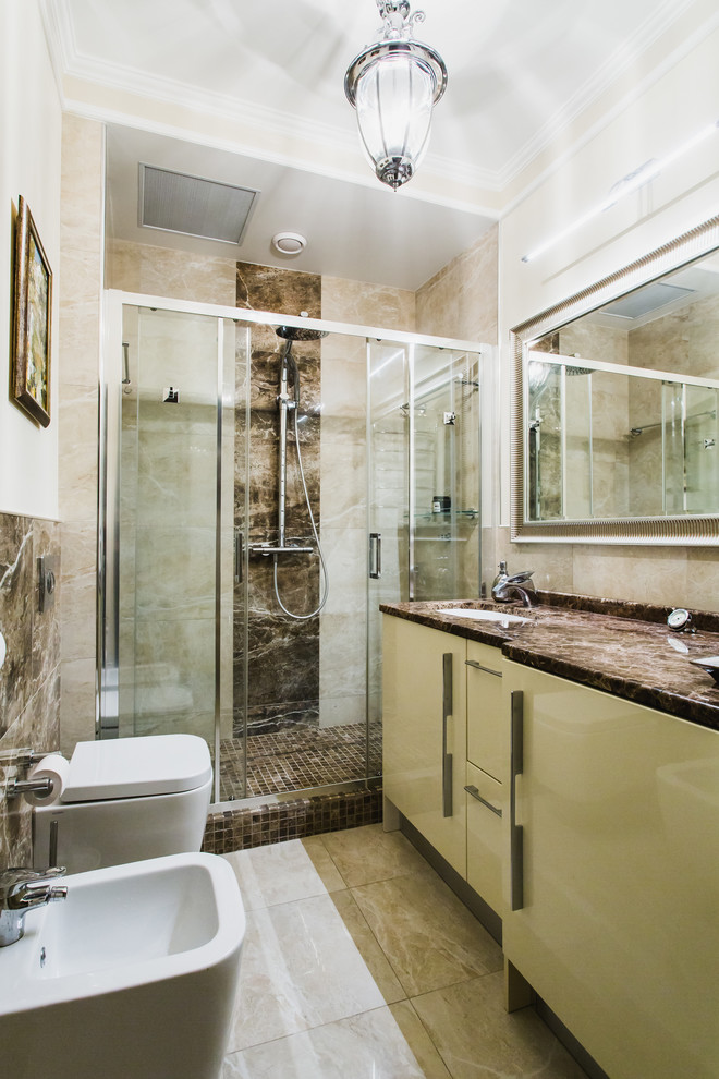Inspiration for a contemporary 3/4 bathroom in Moscow with flat-panel cabinets, beige cabinets, an alcove shower, a wall-mount toilet, beige tile, brown tile, beige walls and an undermount sink.