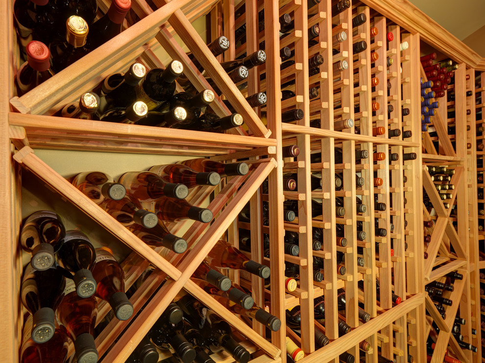 Photo of a mid-sized traditional wine cellar in Vancouver with slate floors, storage racks and brown floor.
