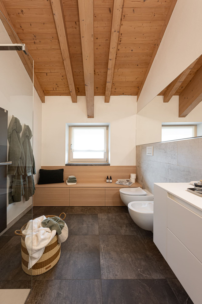 This is an example of a modern cloakroom in Other with white cabinets, grey tiles, ceramic tiles, white walls, ceramic flooring, grey floors, white worktops, a floating vanity unit and exposed beams.