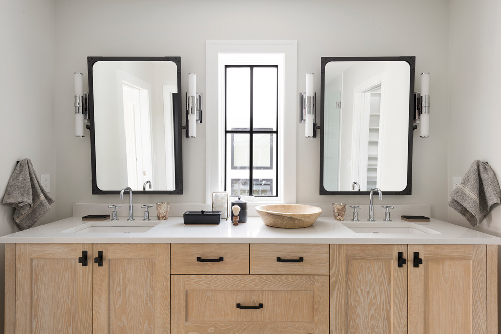 Photo of a country master bathroom in Minneapolis with shaker cabinets, light wood cabinets, white benchtops, white walls and an undermount sink.