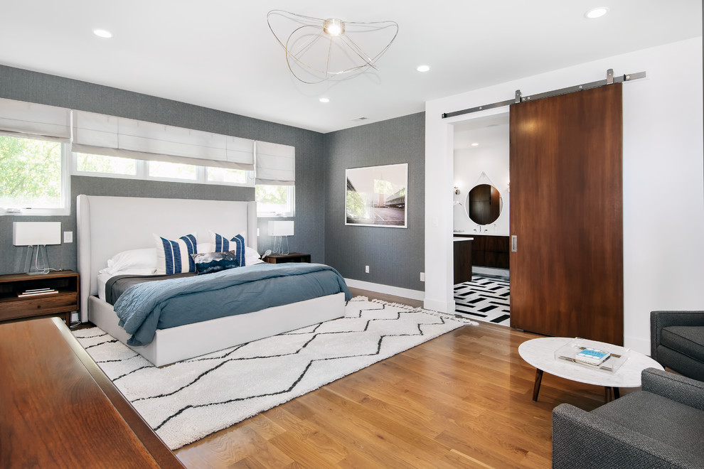 Photo of a midcentury master bedroom in Denver with grey walls, medium hardwood floors and no fireplace.