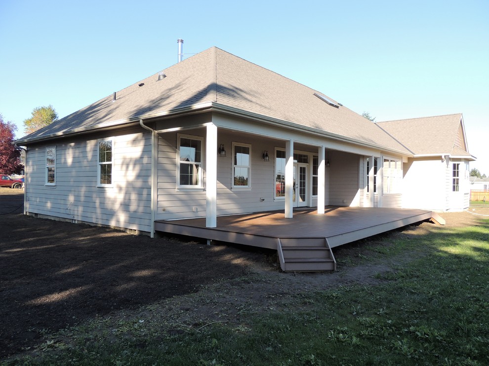 Deck - large transitional backyard deck idea in Seattle with a roof extension