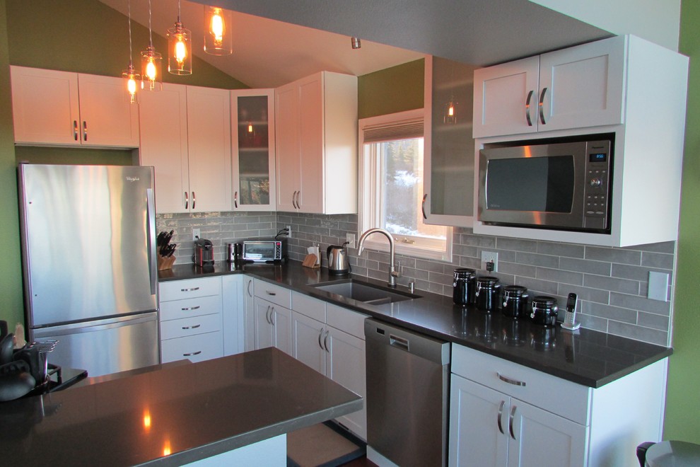 Eat-in kitchen - mid-sized transitional l-shaped medium tone wood floor and brown floor eat-in kitchen idea with a double-bowl sink, recessed-panel cabinets, white cabinets, gray backsplash, stainless steel appliances, an island and subway tile backsplash
