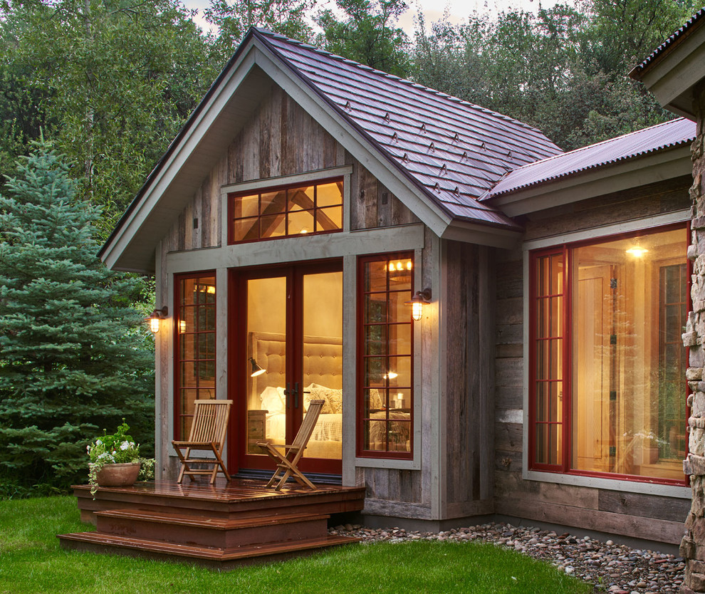 Inspiration for a country one-storey exterior in Denver with wood siding and a gable roof.