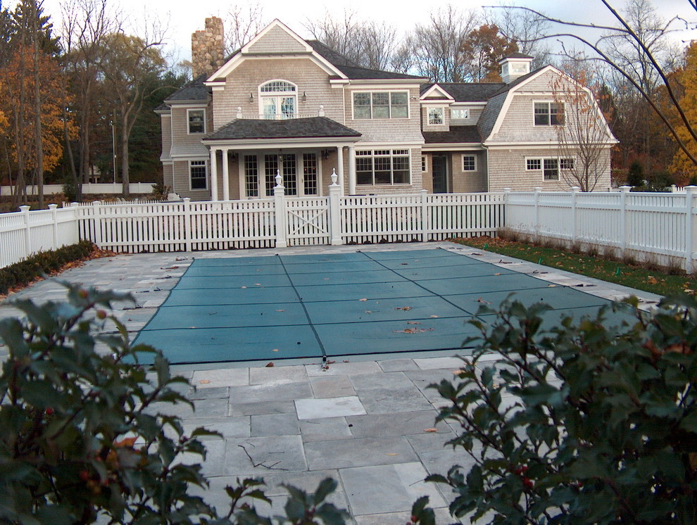 Large traditional courtyard rectangular natural pool in New York with stamped concrete.
