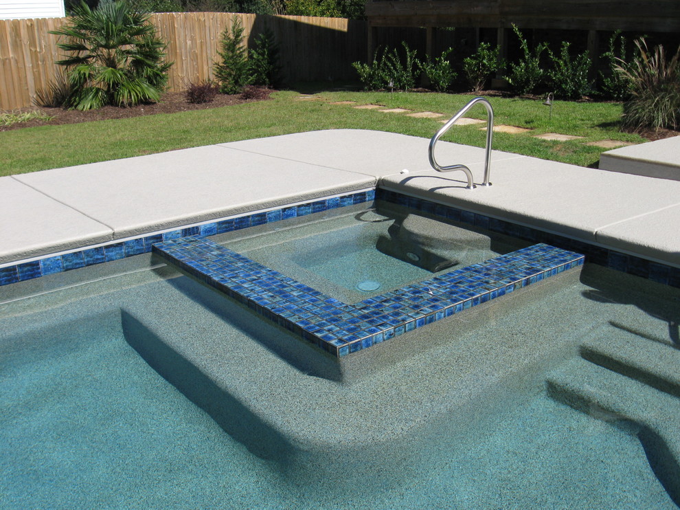 Inspiration for a mid-sized contemporary backyard stamped concrete and rectangular natural hot tub remodel
