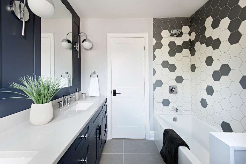 Alcove bathtub - mid-sized transitional kids' white tile and porcelain tile porcelain tile, gray floor and double-sink alcove bathtub idea in Toronto with shaker cabinets, blue cabinets, a one-piece toilet, gray walls, an undermount sink, quartz countertops, white countertops and a built-in vanity