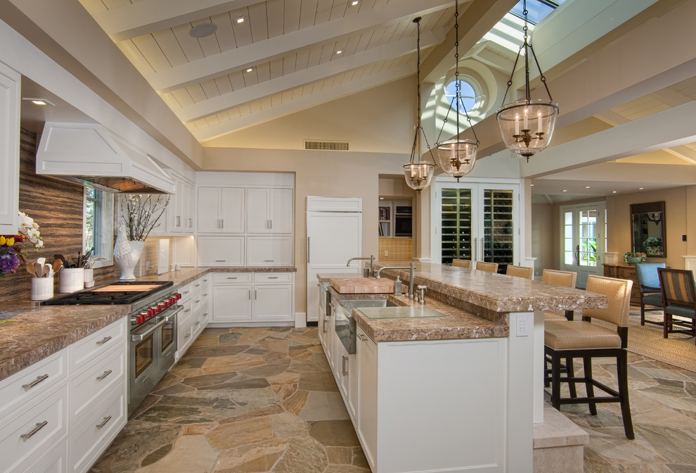 Design ideas for an expansive traditional l-shaped open plan kitchen in San Diego with with island, a farmhouse sink, recessed-panel cabinets, white cabinets, brown splashback and stainless steel appliances.