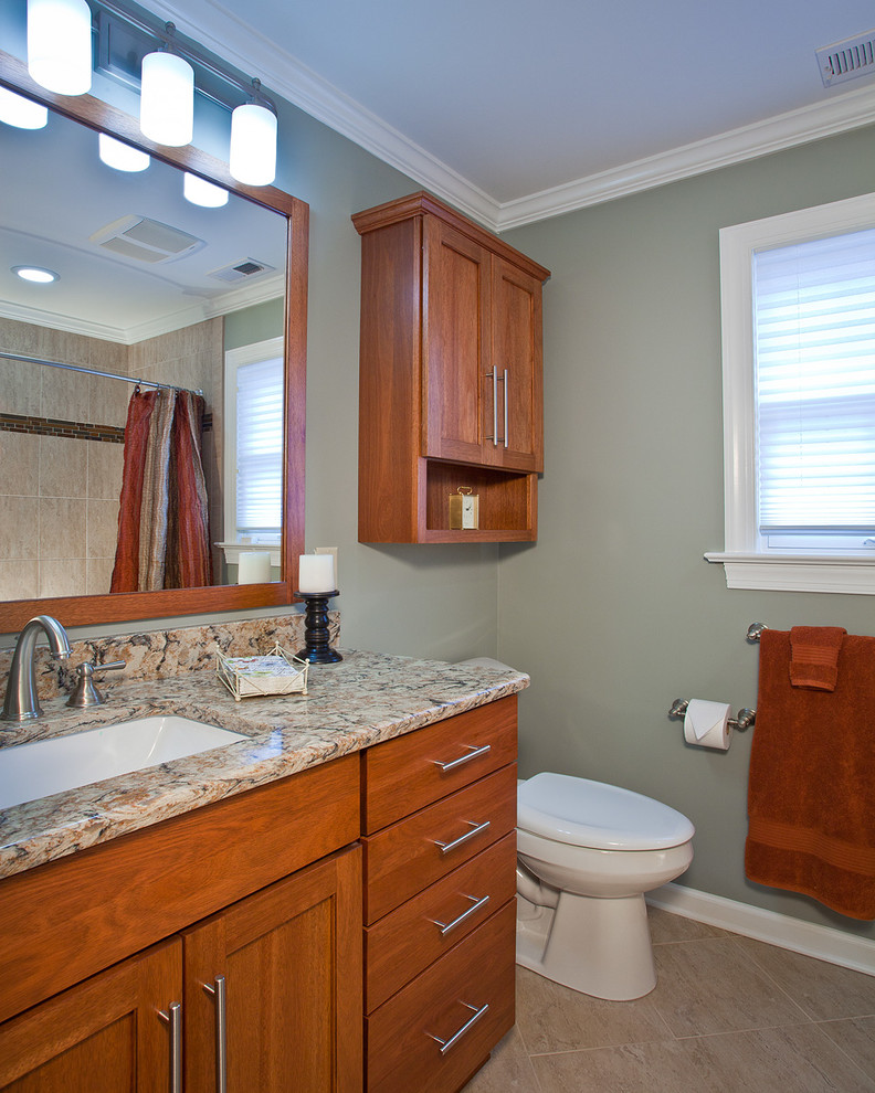Design ideas for a mid-sized transitional 3/4 bathroom in Raleigh with shaker cabinets, medium wood cabinets, a drop-in tub, a curbless shower, a two-piece toilet, beige tile, terra-cotta tile, grey walls, travertine floors, an undermount sink and quartzite benchtops.