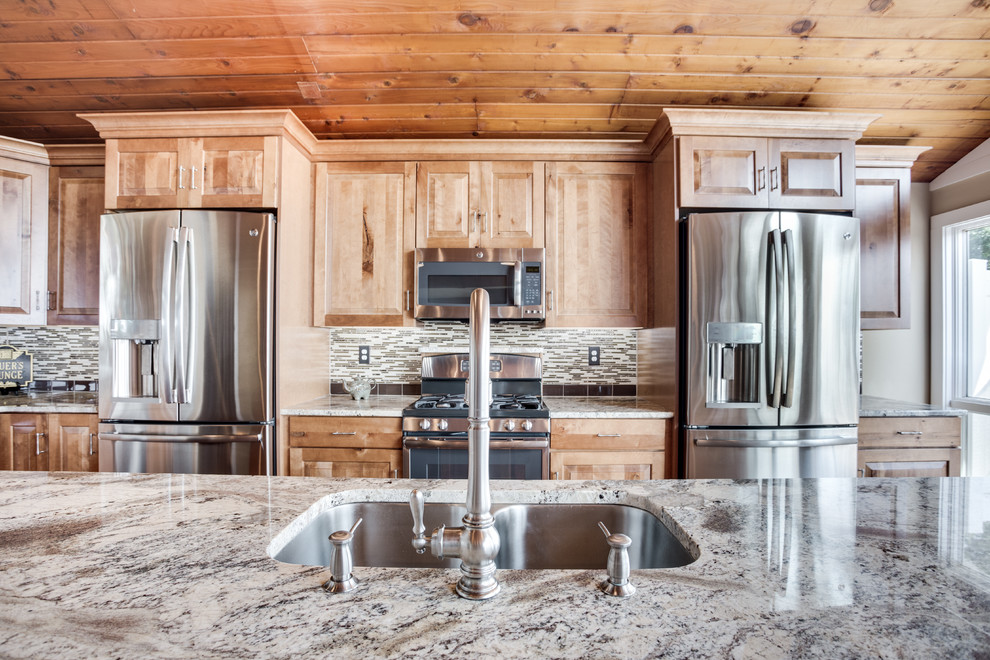 Inspiration for a large rustic kitchen remodel in DC Metro with an undermount sink, raised-panel cabinets, granite countertops, glass tile backsplash, stainless steel appliances and an island