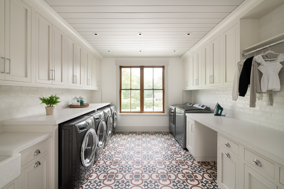 Design ideas for an expansive country laundry room in New York with a farmhouse sink, beaded inset cabinets, white cabinets, quartz benchtops, white splashback, subway tile splashback, white walls, ceramic floors, a side-by-side washer and dryer, blue floor, white benchtop, timber and planked wall panelling.